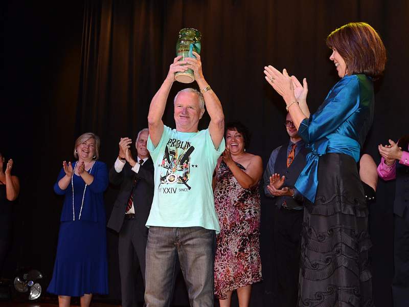 Former Mayor Scott Padgett holding up Dancing for the Arts prize