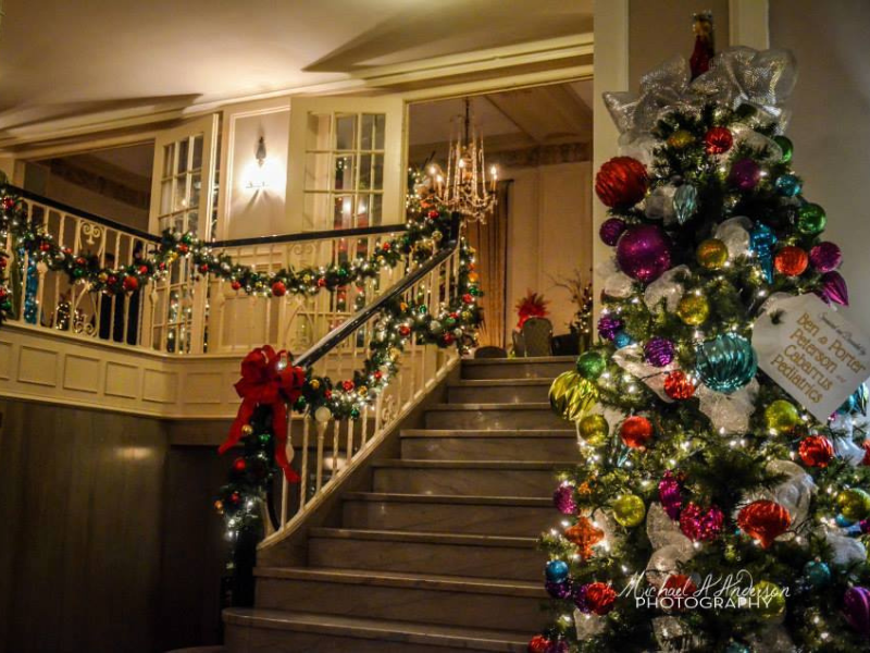 decorated stairway with Christmas tree and garland
